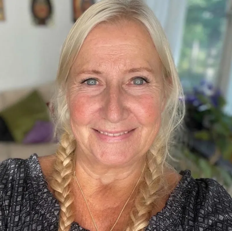 Josefina Andersson ler mot kameran, med ljust hår i två flätor, i ett ljust rum med växter